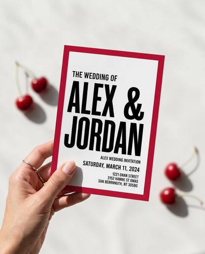 Hand holding cherry red modern wedding invitation
